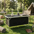 AeroTable roll-up aluminum camp table with coffee mug on top in sunny meadow