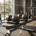 Adjustable dumbbells on workout bench in home gym